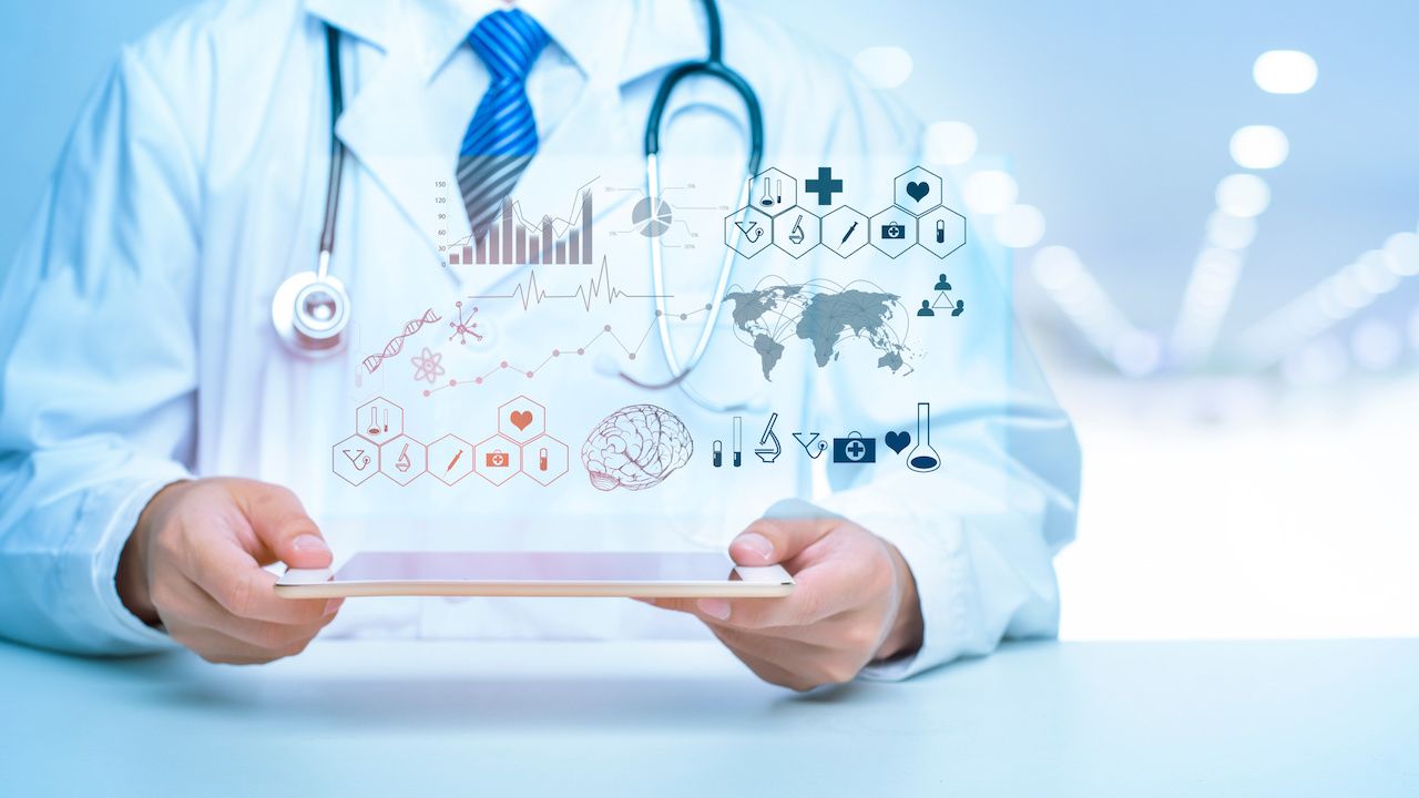 Physician holding a tablet with data anaytics | Image credit: tonefotografia - stock.adobe.com