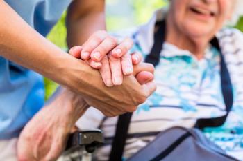 Caregiver and patients holding hands