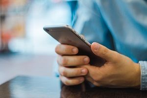 a man holds a smartphone