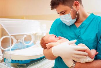 nurse holding newborn baby