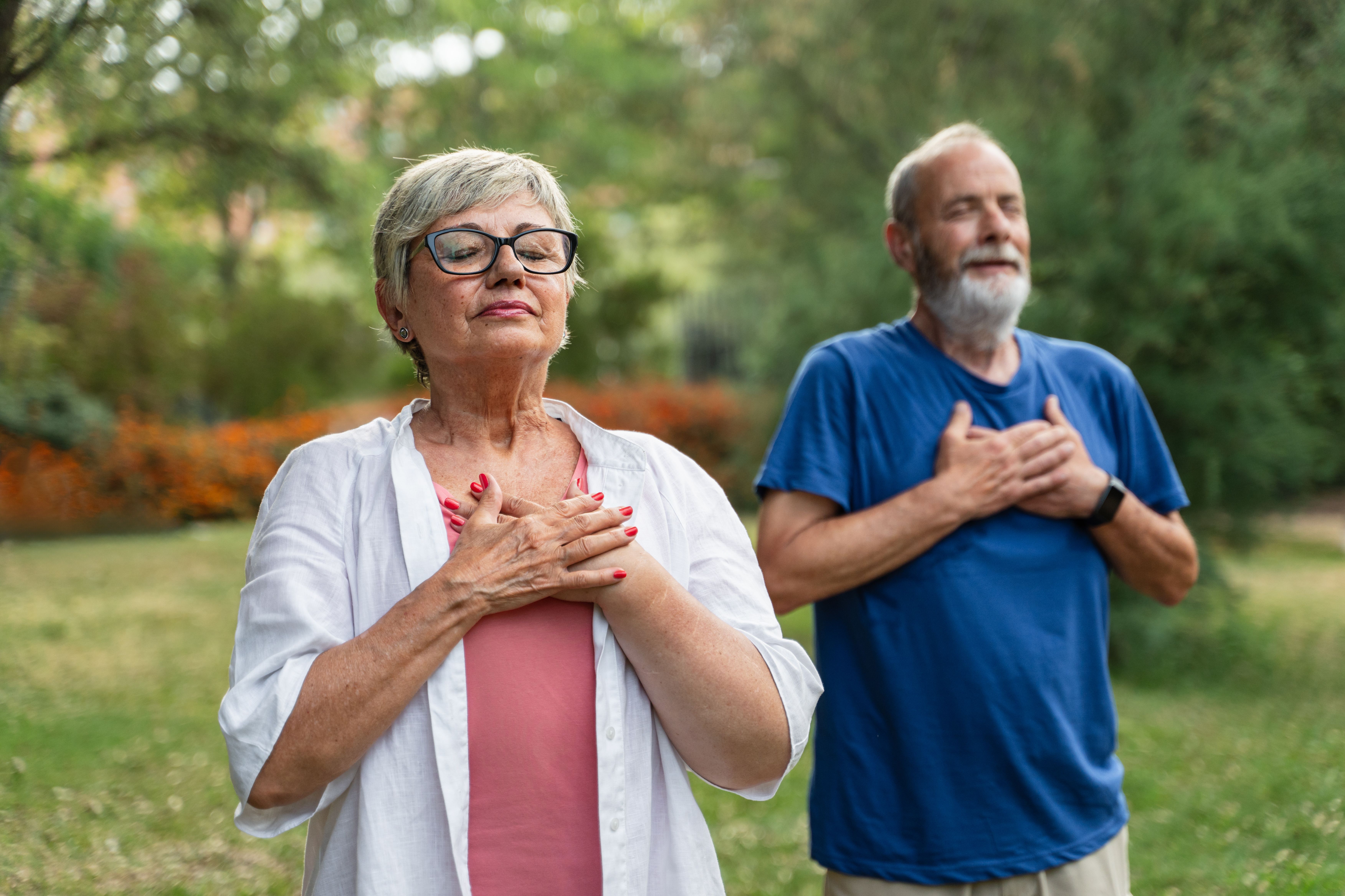 Older couple outside holding their hands to their hearts | Image credit: EFStock – stock.adobe.com