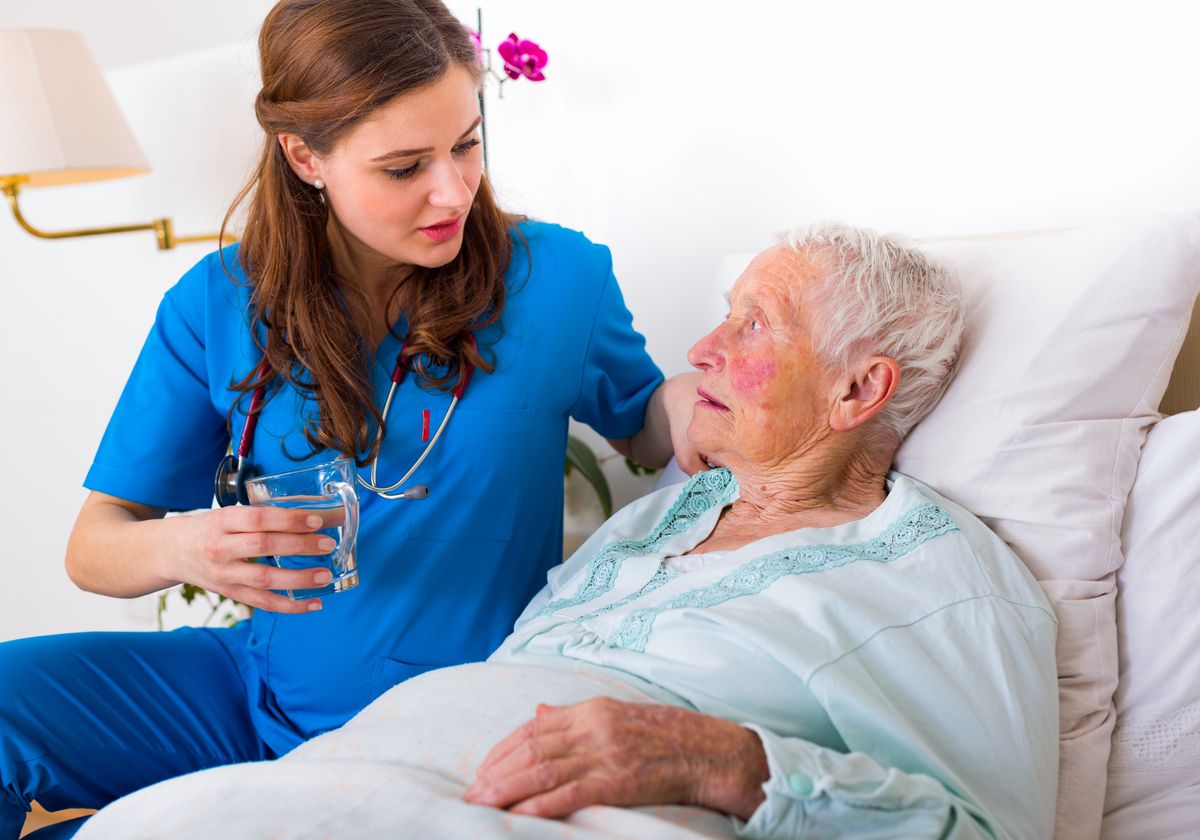 patient in bed with nurse