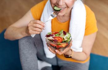 Older woman eating salad on yoga mat | Image credit: Prostock-studio – stock.adobe.com