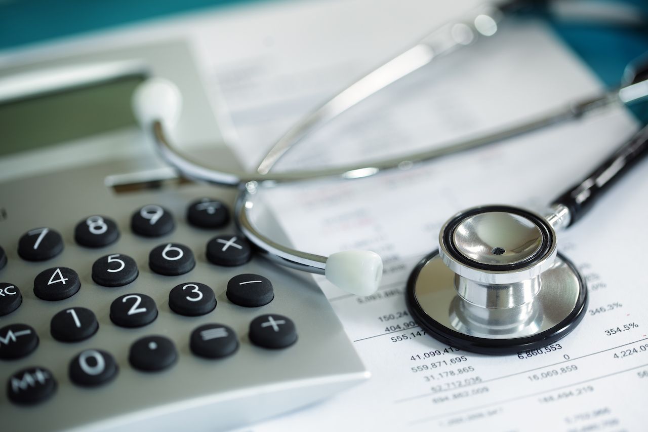 Calculator and stethoscope on financial sheets | Image credit: Brian Jackson - stock.adobe.com.jpeg