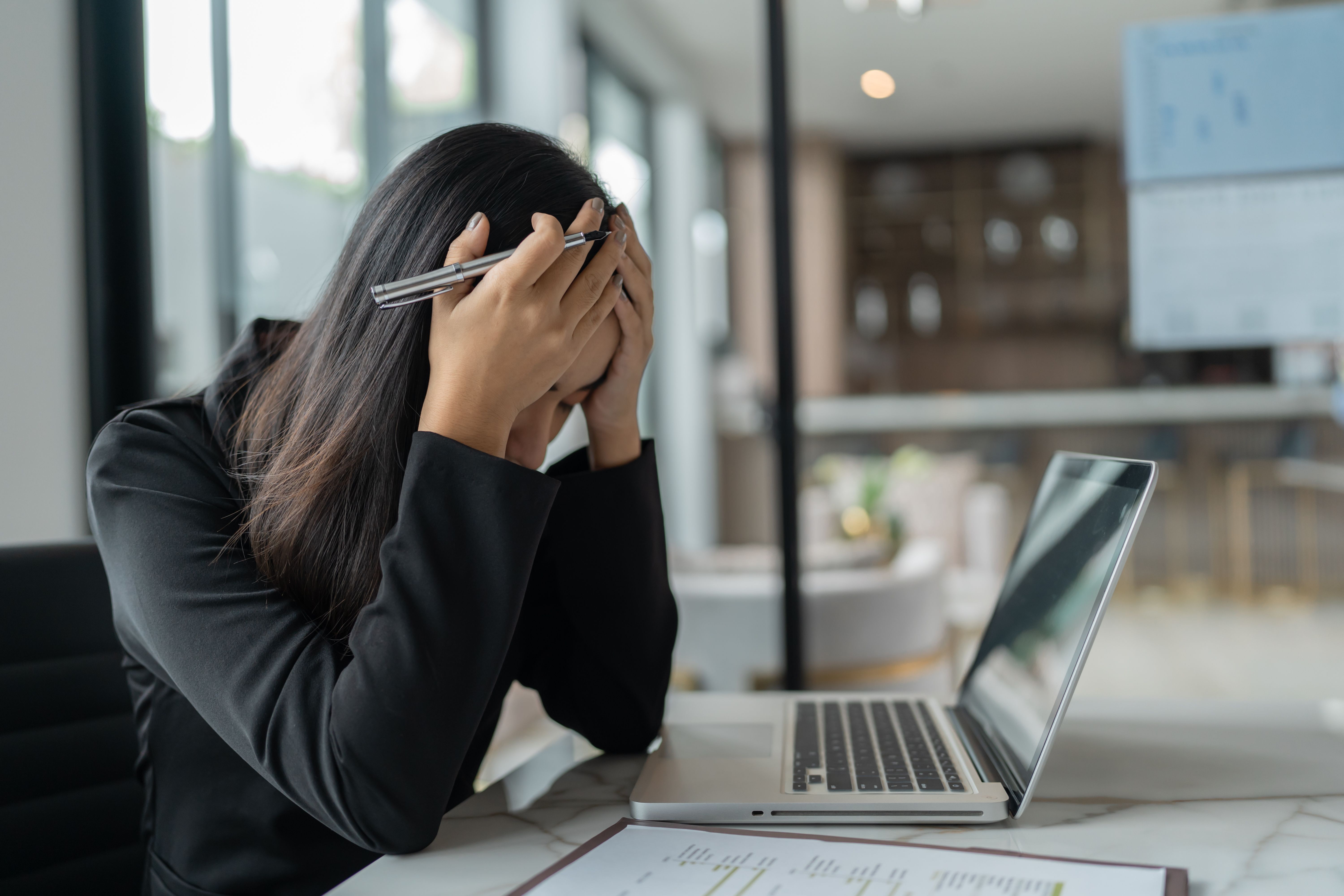 Stressed female employee | Image Credit: Charlie's - stock.adobe.com