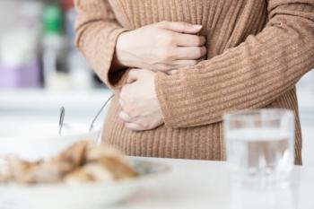 Person holding abdomen | Image credit: Satjawat – stock.adobe.com