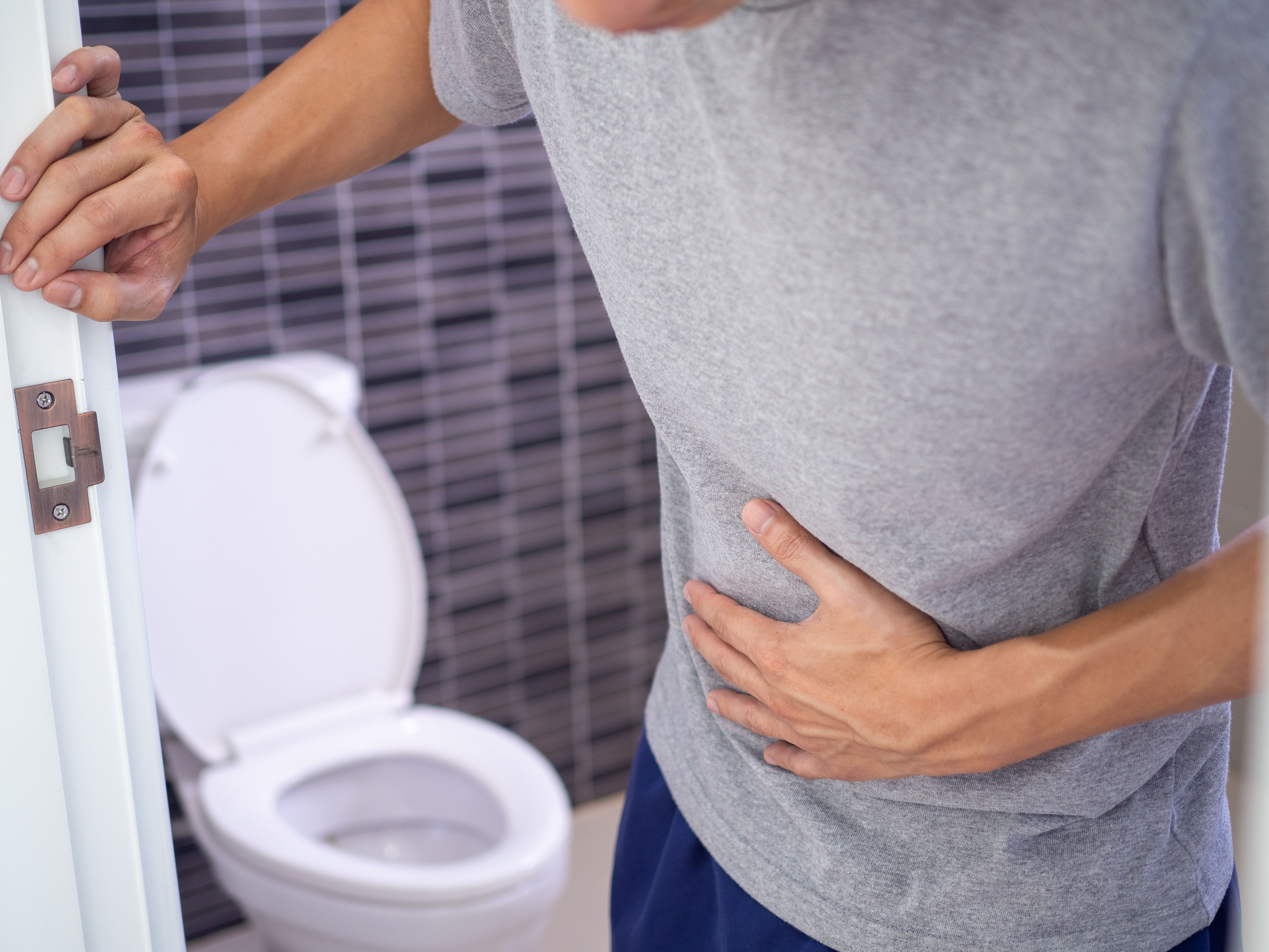 Man clutching his stomach. | Image credit: @Shisuka_AdobeStock.jpeg