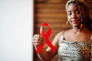 Black woman holding HIV ribbon | Image credit: AS Photo Family - stock.adobe.com