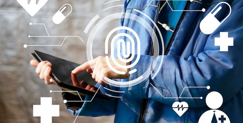 doctor holding tablet, graphic of medical symbols