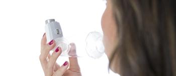 woman using inhaler 