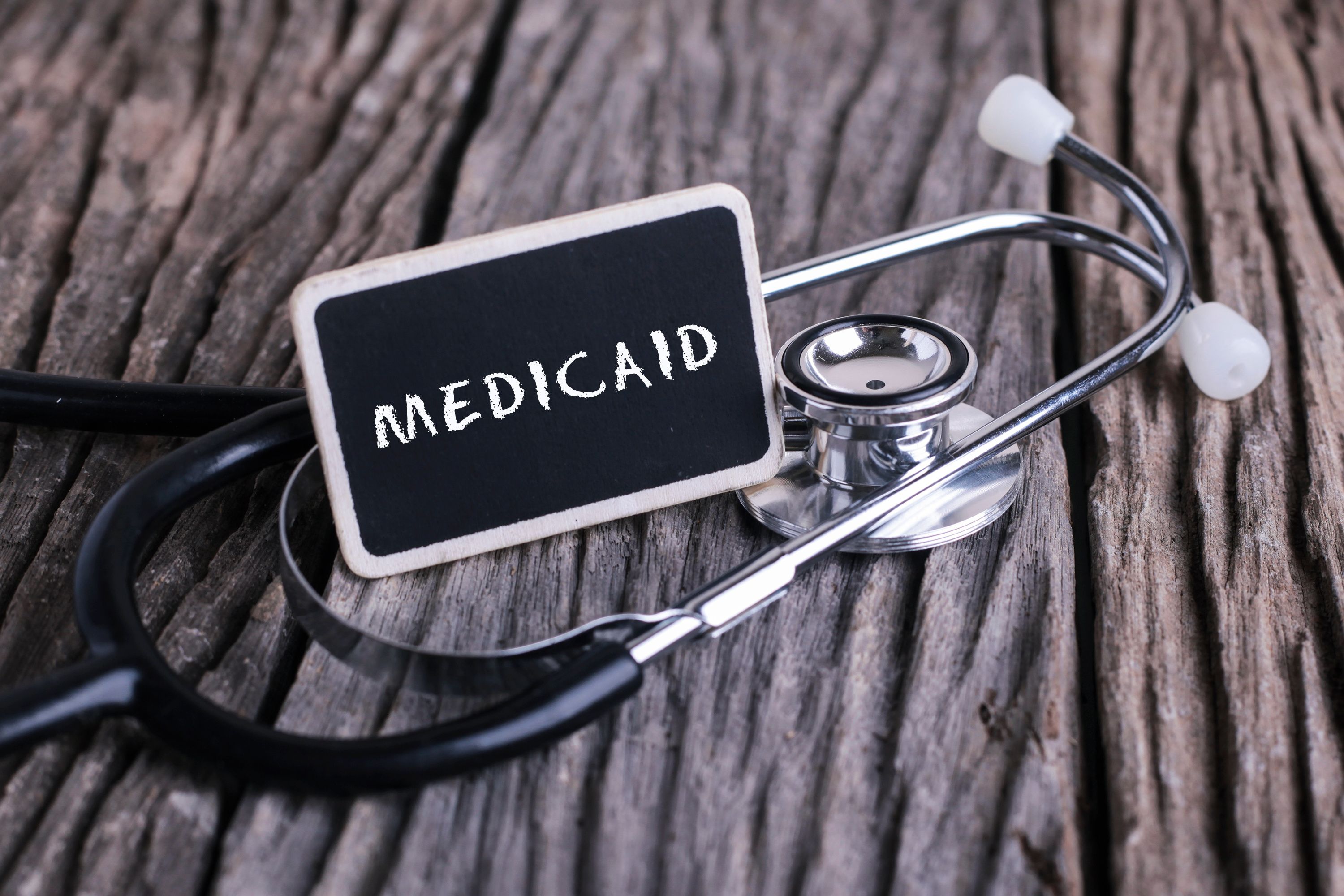 medicaid written on chalk board leaning on stethoscope | Image Credit: nelzajamal - stock.adobe.com