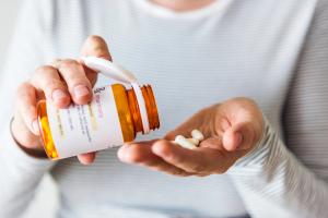woman taking pills from bottle | Image credit: Rawpixel.com - stock.adobe.com