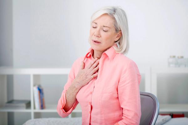 Older women holding chest while breathing out | Image credit: RFBSIP - stock.adobe.com
