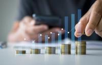 Rising columns of coins with an overlaid bar chart | Image credit: THAWEERAT - stock.adobe.com