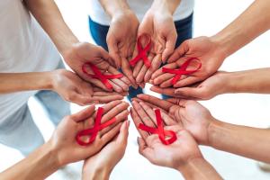 People holding HIV awareness ribbons | Image credit: Vasyl - stock.adobe.com