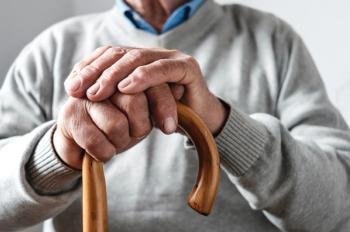 man resting hands on top of walking cane | Image Credit: sergign - stock.adobe.com