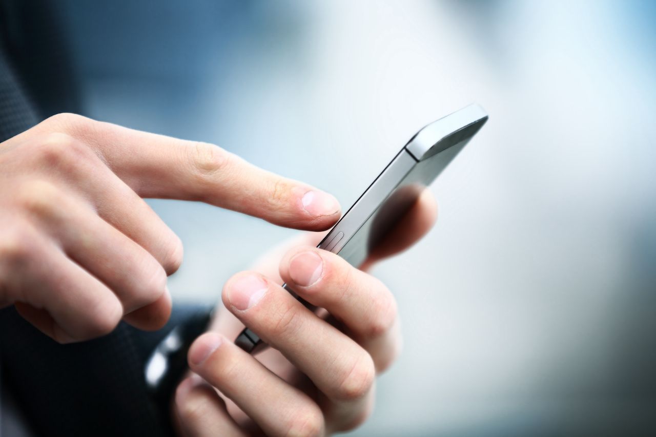 Close up of a man using mobile smart phone: © tatsianamaphoto - stock.adobe.com