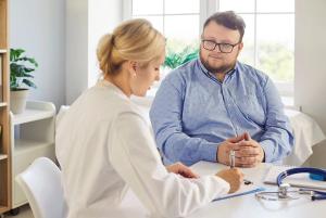 Doctor and patient with obesity | Image Credit: © Studio Romantic - stock.adobe.com