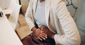 Woman in the office with endometriosis | Image credit: KayExam/peopleimages.com - stock.adobe.com