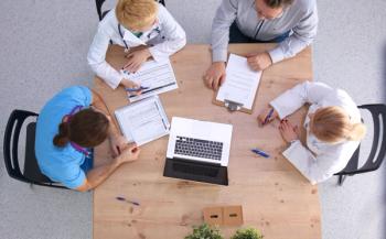 Male and female doctors working on reports in medical office | Image Credit: lenetsnikolai – stock.adobe.com