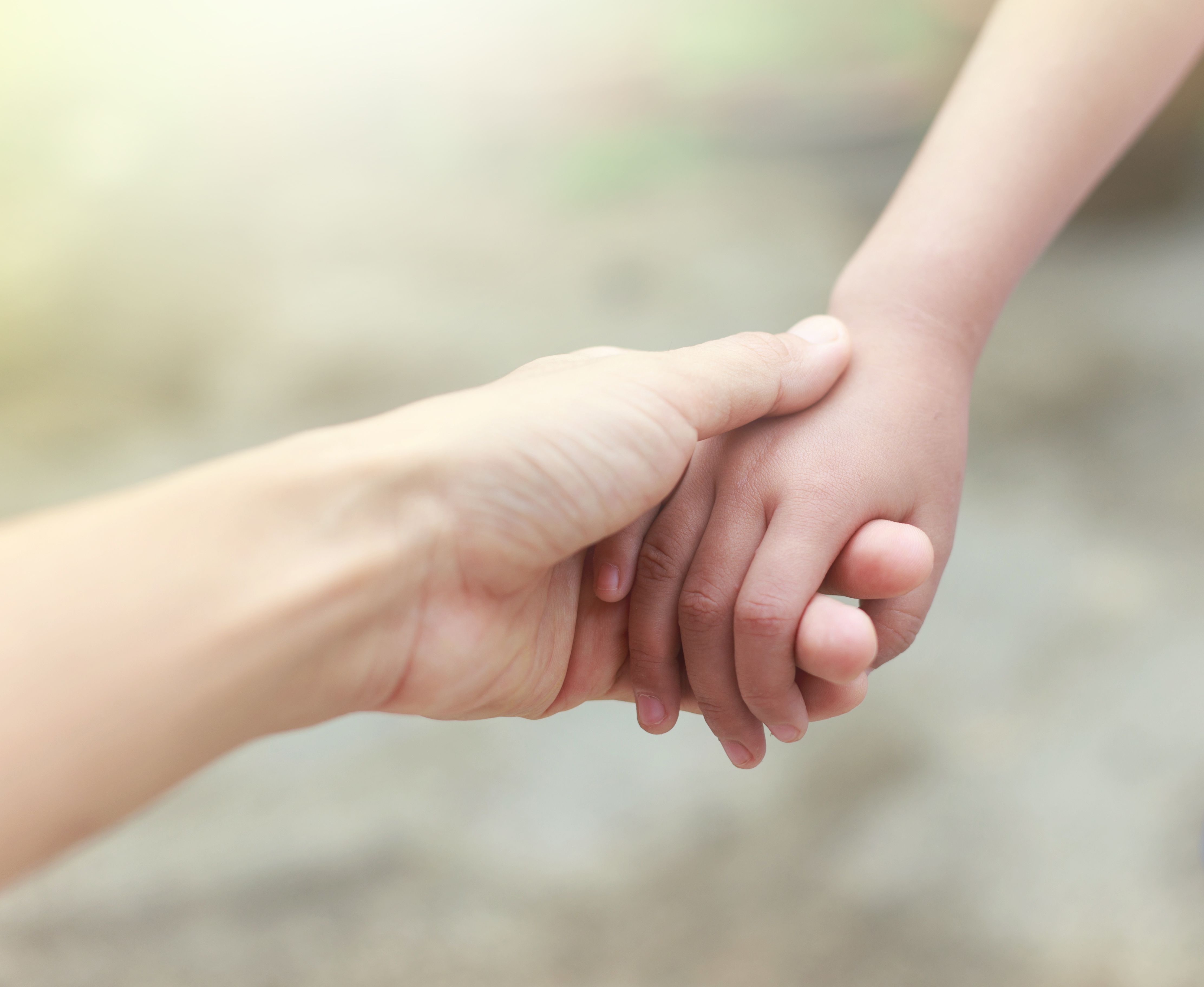 Adults hands joined with child hands