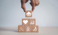  Wooden blocks stacked as a pyramid with a housing icon on the top block being placed. | Image Credit: Bussarin - stock.adobe.com .jpeg