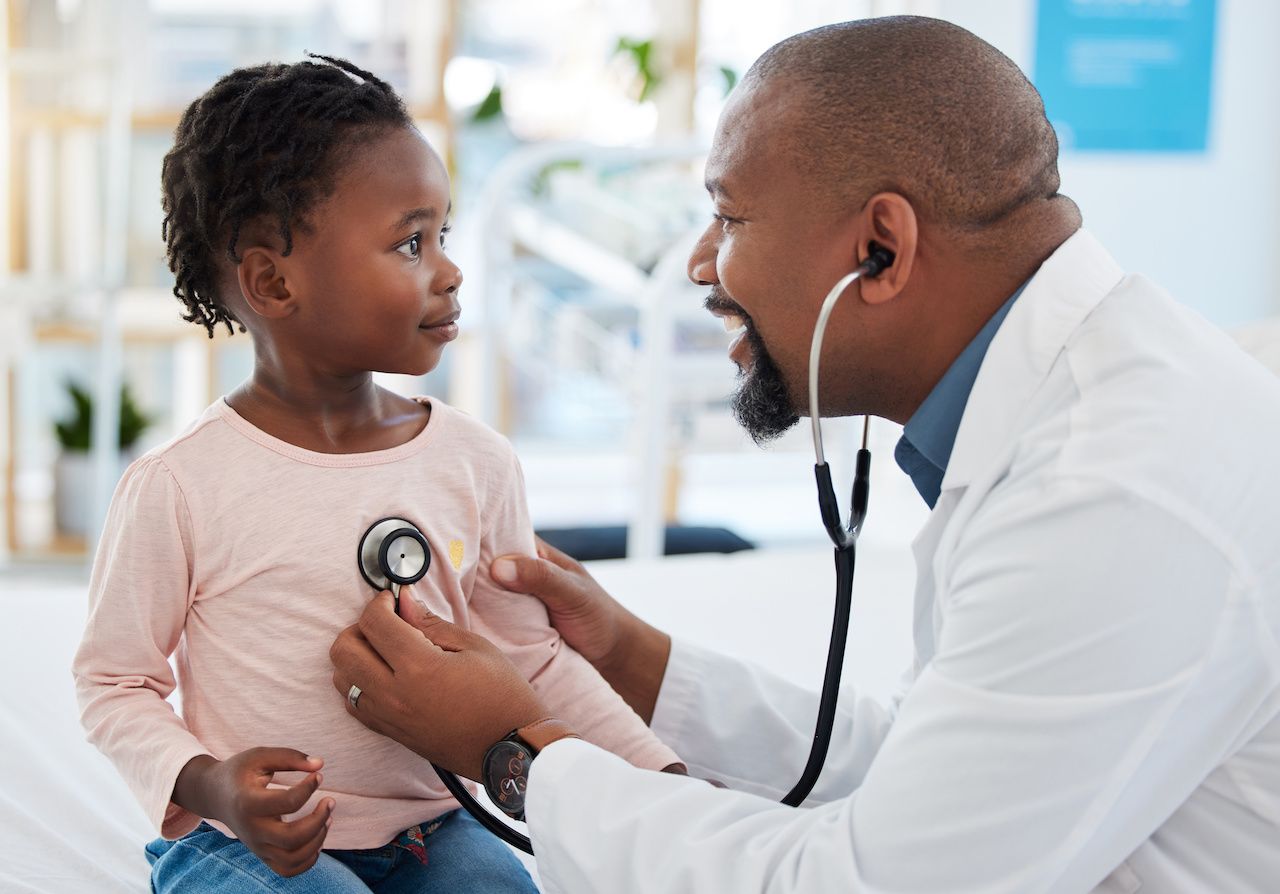 Pediatrician, consulting and stethoscope for lungs or chest checkup with doctor in medical healthcare hospital or clinic. Medicine, young patient and black man therapist listening to heart of baby: © Nina Lawrenson/peopleimages.com - stock.adobe.com