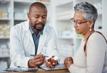 Pharmacist with patient | Image Credit: © Clayton D/peopleimages.com - stock.adobe.com