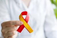 Doctor holding red and yellow ribbon | Image Credit: Ekaterina - stock.adobe.com