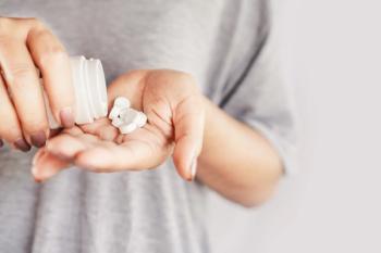 Patient pouring pills into hand | Image credit: doucefleur – stock.adobe.com