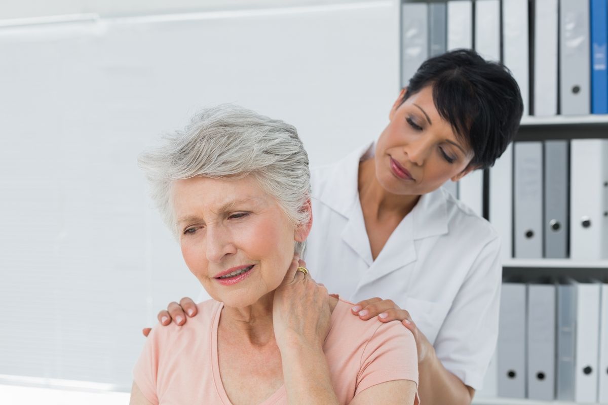 Image of a doctor examining a patient's neck