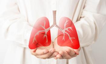 Doctor with hands holding an image of lungs | Image credit: Orawan - stock.adobe.com