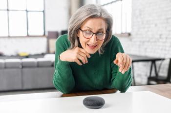 Older woman interacts with smart speaker technology | Image credit: Vadim Pastuh - stock.adobe.com