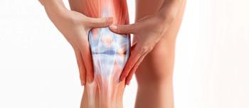 Image of partially exposed knee that is inflamed with persons hands rubbing it due to pain.| Image Credit: BigBlueStudio - stock.adobe.com