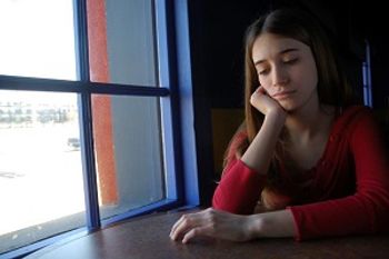 a teen girl looks sad