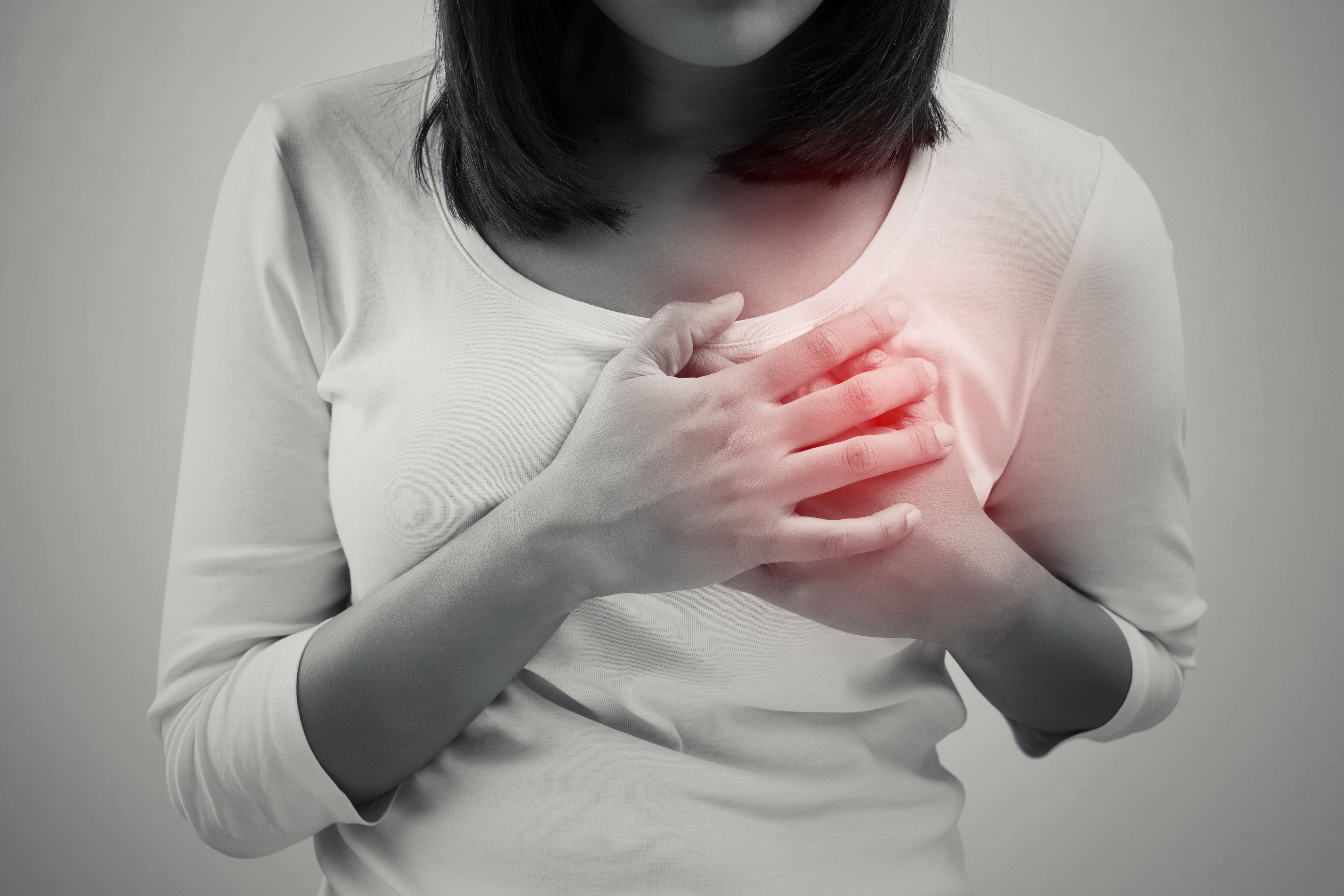 woman holding a hand over her heart