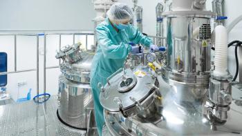 Pharmaceutical factory woman worker in protective clothing operating production line in sterile environment | Image credit: © Ivan Traimak - © Ivan Traimak - stock.adobe.com 