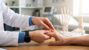 Doctor checking patient hand and finger joints during rheumatology exam on desk, arthritis diagnosis and professional medical care. | Image Credit: ©Iryna - stock.adobe.com
