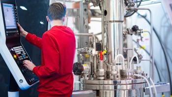 Grispb/Stock.Adobe.com–technician setting data collection of monitoring sensors in bioreactor