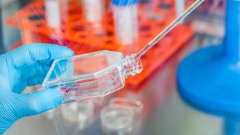 anamejia18/Stock.Adobe.com – photo of a scientist's hands filling or inoculating a cell culture flask