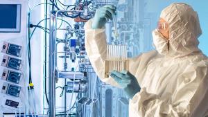 A man in protective clothing with test tubes in his hands against the background of a laboratory bioreactor.Experiments in the field of Microbiology. Pharmaceutical research.Synthesis of new chemicals | Image credit: © Grispb - © Grispb - stock.adobe.com