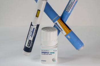 Three injection pens labeled Wegovy, Ozempic, and Victoza crossed behind a bottle of Wegovy semaglutide 1.5 mg tablets on a white background. | Image Credit: © silukstockimages - stock.adobe.com