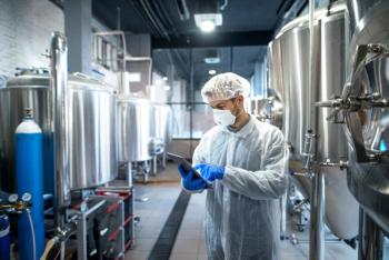 Technologist in white protective uniform controlling industrial process using tablet computer. | Image Credit: © littlewolf1989 - stock.adobe.com