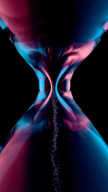 Hourglass illuminated in red and blue on a black background | Image credit: ©Juri – Stock.Adobe.com