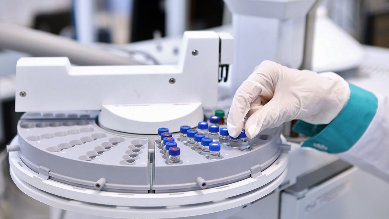 Quality Control Laboratory medicine. Chromatograph operation. A woman makes an analysis on a gas chromatograph. Development of a new vaccine against the covid-19 virus. | Image Credit: © neznamov1984 - © neznamov1984 - stock.adobe.com