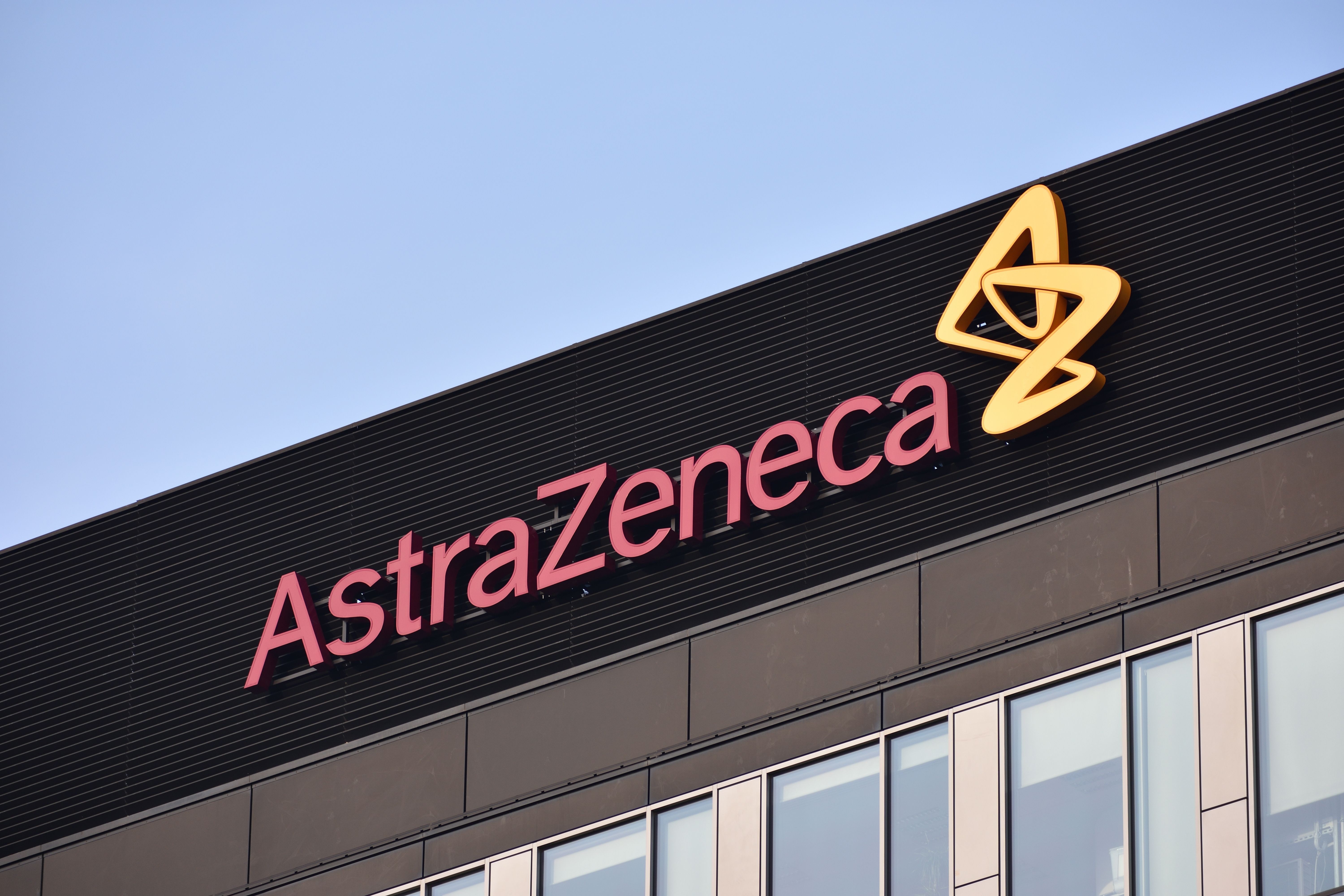 AstraZeneca sign, logo, symbol on the facade of AstraZeneca Poland, multinational pharmaceutical corporation, developer of COVID-19 vaccine. WARSAW, POLAND - NOVEMBER 28, 2021 | Image Credit: © OleksKao - stock.adobe.com