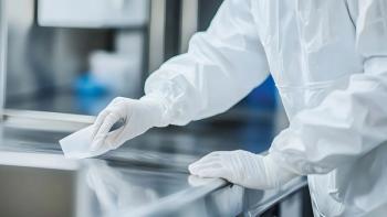 Close-up of gloved hands in a cleanroom meticulously wiping a stainless steel surface. Maintaining sterility is paramount in this precise environment. | Image Credit: ©Aditya – stock.adobe.com