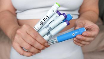 A person holding several GLP-1 injection pens. | Image Credit: © Kateryna - stock.adobe.com