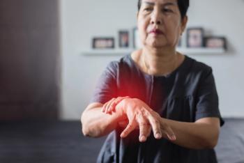 Elderly Parkinson's disease patient with symptoms in hand representing unmet need for disease-modifying dopaminergic cell therapy. | Image Credit: ©gballgiggs -stock.adobe.com