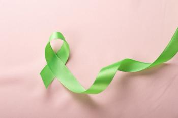 Green ribbon on brown background for Lymphoma Cancer and mental health awareness raising support patient living with illness concept | Image Credit: © Aleksei - stock.adobe.com